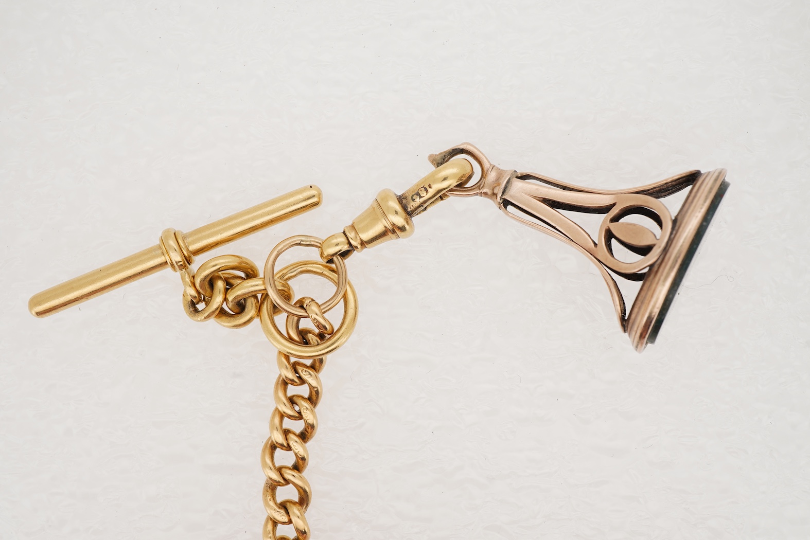 A late Victorian 18ct gold half hunter quarter repeating keyless lever pocket watch, by Alexander Guillaume, Spencer St, Northampton Sq. London, together with a similar 18ct gold curb link albert, hung with a yellow meta